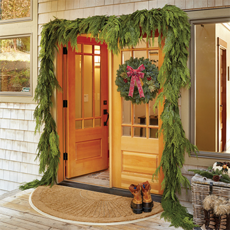 front door decorated with fresh greenery
